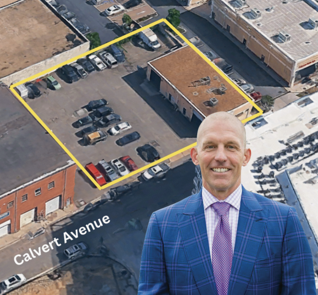 Aerial view of a parking lot and building outlined in yellow along Calvert Avenue, with a smiling man in a blue plaid suit and pink tie in the foreground.